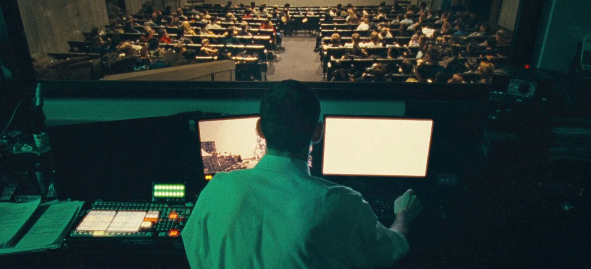 A student crew mixing a live lecture from the back of an auditorium